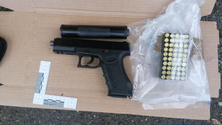 A handgun, bullets and silencer are displayed after a criminal network bust by Metropolitan Police in a joint operation with the National Crime Agency (NCA) and European partners in London, Britain, in this undated image released July 2, 2020. The NCA and European partners shared data from the encrypted communication system EncroChat with the Met Police, which led them to make over 170 arrests and seize 13.4 million pounds in cash.